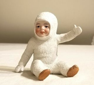 Miniature Bisque Snow Baby,  Sitting & Waving.  Snow Covered.  Early 1900s German
