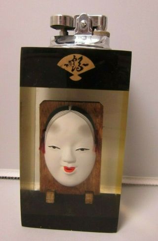 Vintage Tall Lucite Table Lighter W/ Asian Oriental Face Mask On Wood Frame