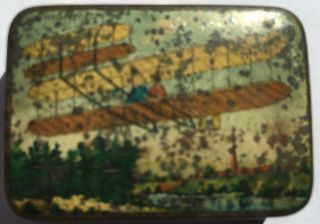 Early aviation tin box c.  1908 showing the Wright Flyer airborne.  Coloured metal 3