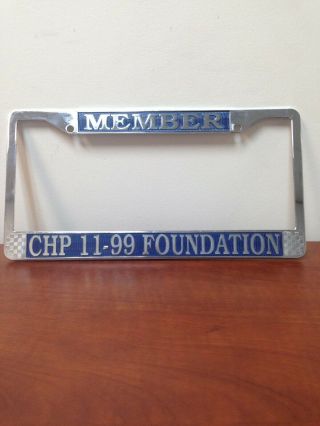 CHP 11 - 99 FOUNDATION LICENSE PLATE FRAME.  Blue lettering.  Made of metal. 2