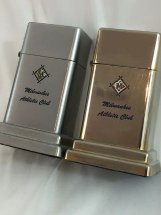 2 Barcroft Zippo Table Lighters - Both Advertising The Milwaukee Athlete Club