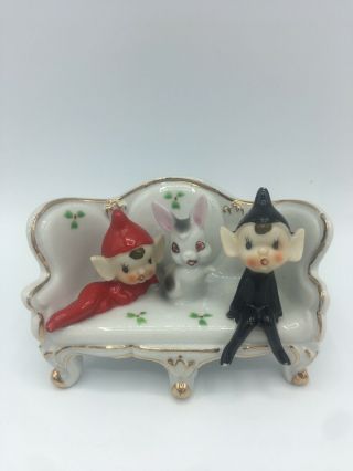 Two Sweet Little Pixie Elves Sitting On A Couch With A Rabbit Porcelain Vintage