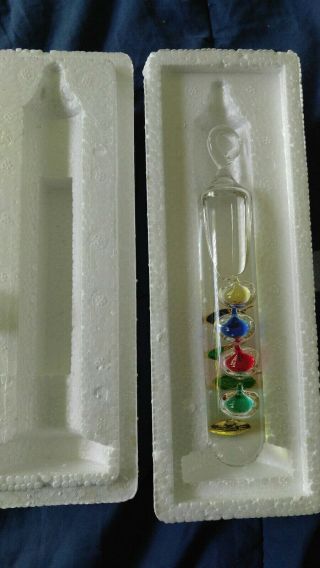 Desktop Galileo Glass Thermometer With A Metal Stand.