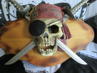 Disney Pirates Of The Caribbean Mounted Skull And Crossed Swords Plus Flag.