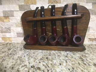 Wood Stand And 5 Matching Carey 1/2 Bent Burgandy Colored Estate Pipe