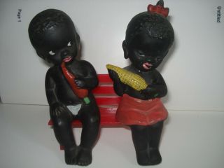 Black Americana Ceramic Boy And Girl Shelf Sitters Sitting On A Red Bench