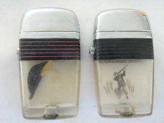 Vintage (2) Larger Scripto Vu Lighters With Fishing Lure & Duck Hunter