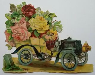 V.  Lge Antique Embossed Victorian Scrap.  Car/flowers & Milestone.  App.  24x19cms.