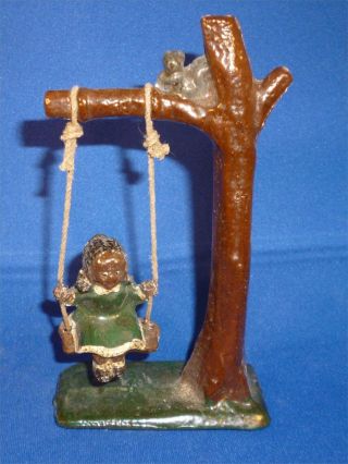 N Very Rare Old Hand Painted Lead Figure Of Black Girl On A Tree Swing