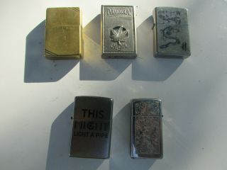 Four Vintage Zippo Lighters And One Butane Lighter.