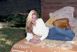 35mm Color Negative Sexy Blonde In Jeans Long Legs On Bed.