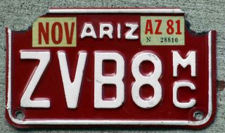 White On Red Arizona Motorcycle License Plate With A 1981 Sticker