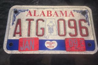 Red White And Blue Alabama Motorcycle License Plate Featuring A Motorcycle Rider