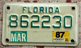 Green On White Florida Motorcycle License Plate With A 1987 Sticker