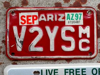 White On Red Arizona Motorcycle License Plate With A 1997 Sticker