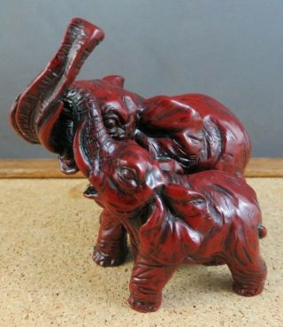Vintage Red Resin Faux Cinnabar Double Elephant Figurine Trunks Up Together