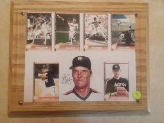 Nolan Ryan Autographed Picture Mounted On Wood Plaque.