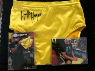 Hulk Hogan Autographed Yellow Trunks TWO SIGNATURES W/ PICTURE OF HOGAN SIGNING 2