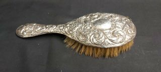 A Solid Silver Grooming Brush With Floral Embossed Patterns.  Birmingham 1923