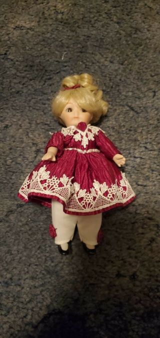 Small Vintage Porcelain Doll In A Red Outfit With Blonde Hair