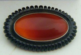 A Rare C19th Whitby Jet Mourning Brooch Set With A Scottish Red Agate Cabochon