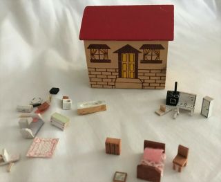A Vintage Miniature Dollhouse With Furniture For The Dollhouse