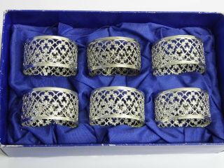 A Set Of Six Vintage White Metal Pierced Decorated Napkin Rings