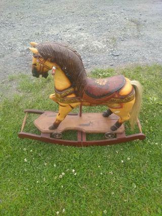 Antique Wooden Rocking Horse With Cast Iron Wheels And Real Horse Hair.