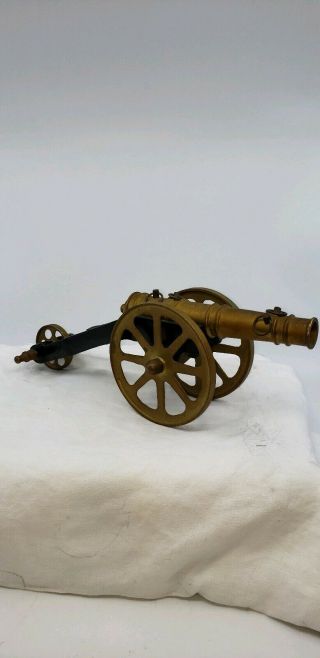 Antique Brass And Iron Toy Cannon With Three Wheels.