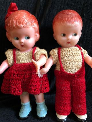 Vintage Celluloid Boy & Girl Dolls In Crocheted Outfits Both Ate Rattles