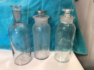Three Large Apothecary Bottles With Stoppers