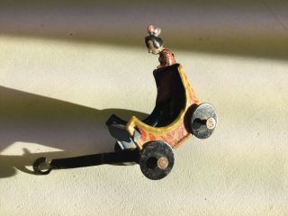 Antique Tin Penny Toy Girl On Painted Cart With Wheels