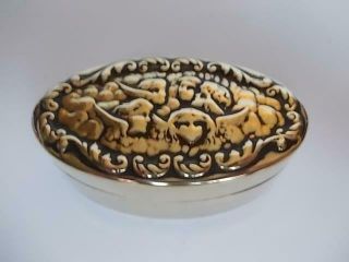 122 / Antique Small Oval Brass Box With The Lid Having Cherub Design