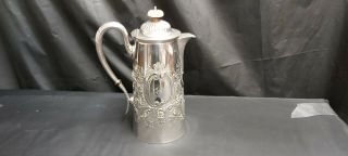 An Antique Silver Plated Tea Pot With Embossed Patterns By Daniel & Arter.
