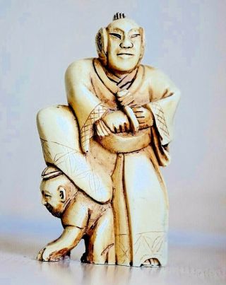 A Japanese Carved Resin Netsuke Okimono Samurai Scholar Figure