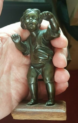 Old Antique Bronze Figure Of A Young Boy Mounted On A Wooden Base