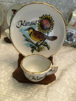 Miniature Tea Cup And Saucer Kansas Souvenir.  Plastic Stand.  Meadowlark And Sunf