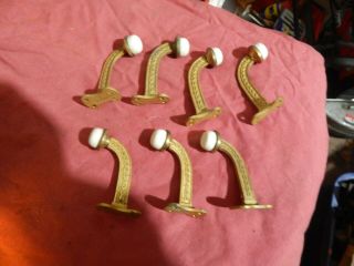 Set of 7 vintage cast iron coat hooks,  porcelain button ends 2