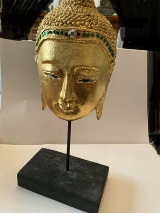 Gold Buddha Head Mask On Wooden Base