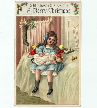 Antique Embossed Christmas Postcard Girl Sitting On Bed W/doll Toys & Stocking