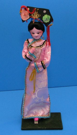 Vintage plastic Doll Oriental souvenir on wooden pedestal and 2