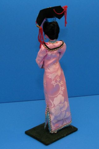 Vintage plastic Doll Oriental souvenir on wooden pedestal and 3