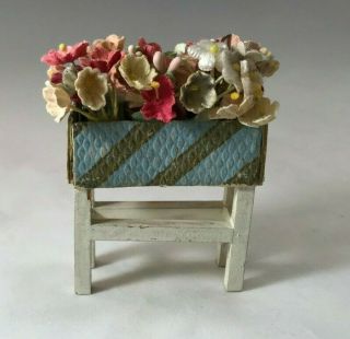 Vintage Plant Stand With Blue And Gold Embossed Paper Planter And Cloth Flowers
