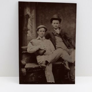 Antique Tintype Photo 2 Young Men Seated Wearing Hats 1 Holding Large Bottle