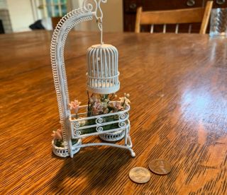 vintage white wicker plant stand and bird cage,  metal wickerwork,  flowers 2
