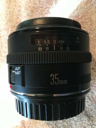 Canon EF 35 mm f/2.  0 IS UMS Wide Angle Lens,  hood cover.  Rarely. 2
